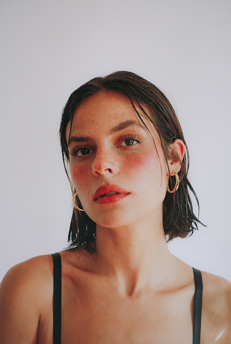 A woman in a black top is posing for a picture